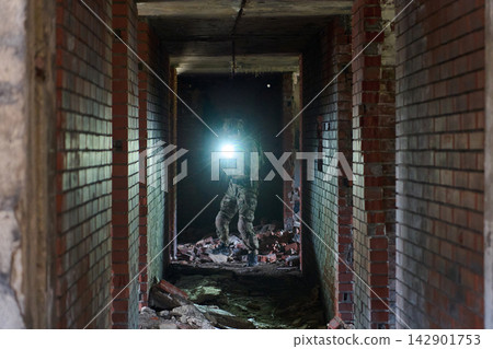 Soldier With Flashlight Exploring Abandoned Brick Corridor in Urban Ruin Tactical Search Soldier With Flashlight Exploring Abandoned Brick Corridor in Urban Ruin Tactical Search 142901753