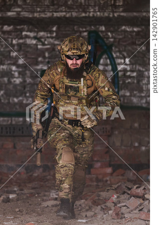 Tactical Soldier in Camouflage Uniform Running With Rifle Through Urban Ruins During Training Exercise Tactical Soldier in Camouflage Uniform Running With Rifle Through Urban Ruins During Training Exercise 142901765
