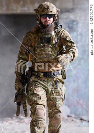 Tactical Soldier in Multicam Combat Gear Walking With Rifle Inside Urban Building Tactical Soldier in Multicam Combat Gear Walking With Rifle Inside Urban Building 142901776