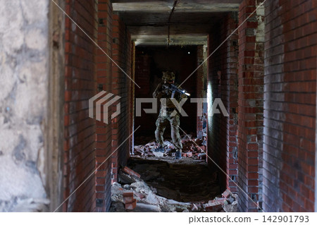 Soldier In Tactical Gear Clearing Abandoned Brick Hallway During Urban Military Training Exercise Soldier In Tactical Gear Clearing Abandoned Brick Hallway During Urban Military Training Exercise 142901793