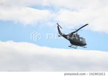 Military Helicopter Flying Over Clouds During Daylight Training Flight Low-Altitude Transport Aviation Military Helicopter Flying Over Clouds During Daylight Training Flight Low-Altitude Transport Aviation 142901811