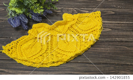 Multicolored hand-knitted fabric. Knitting and crochet lessons. Fashion Multicolored hand-knitted fabric. Knitting and crochet lessons. Fashion 142901855