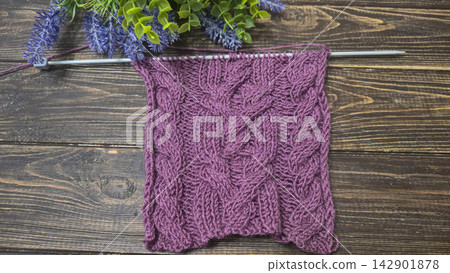 Multicolored hand-knitted fabric. Knitting and crochet lessons. Fashion Multicolored hand-knitted fabric. Knitting and crochet lessons. Fashion 142901878