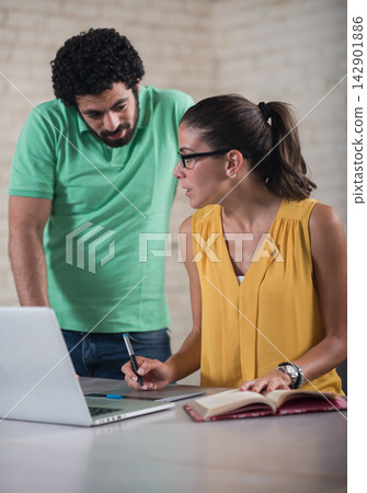 Young Middle Eastern coworkers collaborating in a creative startup coworking office space Young Middle Eastern coworkers collaborating in a creative startup coworking office space 142901886