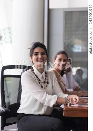 Smiling businesswoman and diverse colleagues in a modern office meeting, confident professional team Smiling businesswoman and diverse colleagues in a modern office meeting, confident professional team 142901953