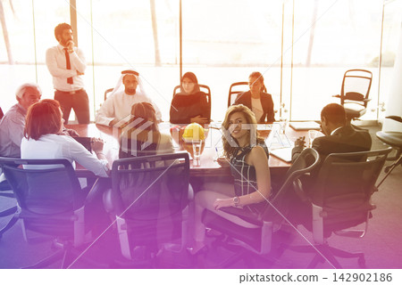 Multicultural Middle Eastern business team in a modern open-space boardroom meeting about strategy and collaboration Multicultural Middle Eastern business team in a modern open-space boardroom meeting about strategy and collaboration 142902186