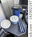 Lunchbox and water bottle placed inside the work vehicle 142902197