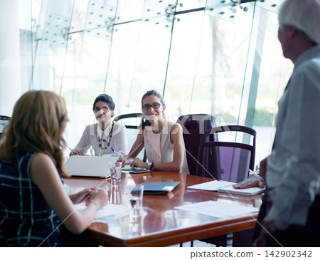 Middle Eastern startup team in a modern corporate meeting room collaborating on strategy and ideas Middle Eastern startup team in a modern corporate meeting room collaborating on strategy and ideas 142902342