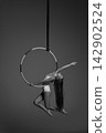 Young gymnast balancing sideways on aerial hoop 142902524