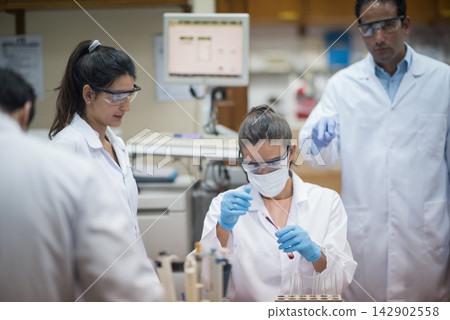 Middle Eastern doctors and medical technicians performing blood testing in a clinical laboratory setting Middle Eastern doctors and medical technicians performing blood testing in a clinical laboratory setting 142902558
