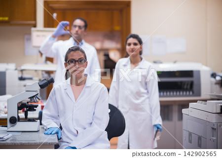 Middle Eastern young doctors and medical technician working together in a blood testing laboratory Middle Eastern young doctors and medical technician working together in a blood testing laboratory 142902565