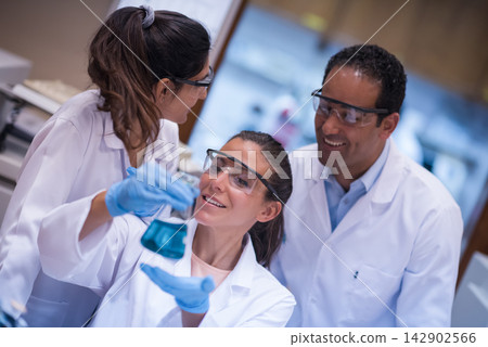 Middle Eastern medical team of young doctors and technician collaborating in blood testing lab Middle Eastern medical team of young doctors and technician collaborating in blood testing lab 142902566