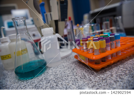 Young medical staff working with blood test tubes and lab equipment in a clinical laboratory 142902594