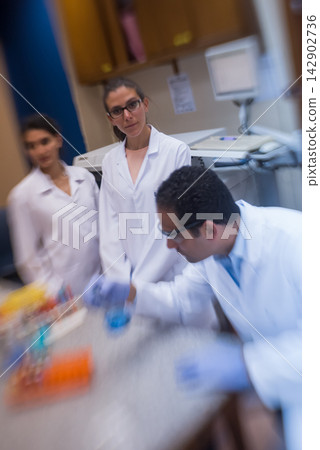 Middle Eastern medical team of young doctors and technician collaborating in a blood testing laboratory Middle Eastern medical team of young doctors and technician collaborating in a blood testing laboratory 142902736