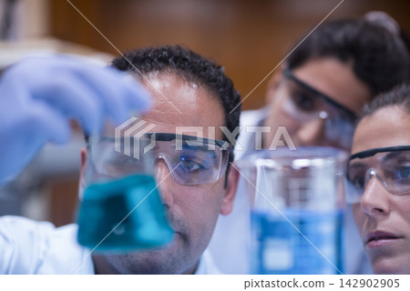 Medical team of doctors and laboratory technicians analyzing blood samples in clinical research lab Medical team of doctors and laboratory technicians analyzing blood samples in clinical research lab 142902905