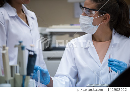 Middle Eastern and Arab female doctors and medical technician working in a blood testing laboratory Middle Eastern and Arab female doctors and medical technician working in a blood testing laboratory 142902922