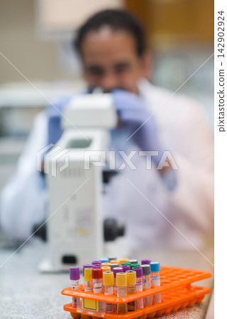 Young Middle Eastern medical technician and doctor working with blood samples in a clinical laboratory setting Young Middle Eastern medical technician and doctor working with blood samples in a clinical laboratory setting 142902924
