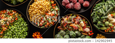 Frozen summer vegetables and fruits in plates, set on a dark background, emphasizing the seasonal preparation for winter storage and future meals, banner Frozen summer vegetables and fruits in plates, set on a dark background, emphasizing the seasonal preparation for winter storage and future meals, banner 142902945