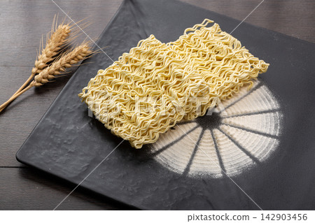 uncooked Instant Ramen Noodle Blocks with Wheat Stalks uncooked Instant Ramen Noodle Blocks with Wheat Stalks 142903456