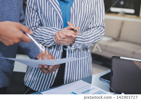 Business professional analyzing financial data on digital tablet dashboard with calculator and laptop, representing accounting software, ERP system integration, performance monitoring. Business professional analyzing financial data on digital tablet dashboard with calculator and laptop, representing accounting software, ERP system integration, performance monitoring. 142903727