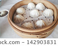 Xiao Long Bao, a staple of Taiwanese cuisine, served in a steamer basket. 142903831