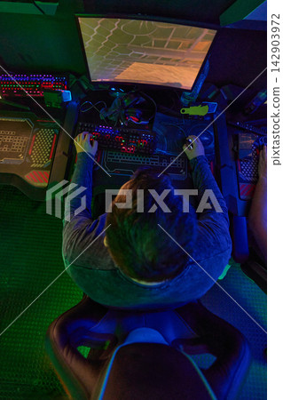 Overhead View Of Gamer Playing On RGB PC With Keyboard And Mouse In Esports Arena Overhead View Of Gamer Playing On RGB PC With Keyboard And Mouse In Esports Arena 142903972