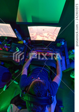 Overhead View of Gamer Playing First-Person Shooter on RGB Gaming PC With Headset Overhead View of Gamer Playing First-Person Shooter on RGB Gaming PC With Headset 142903973