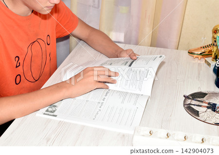 The boy is reading a book. The boy is reading a book. 142904073
