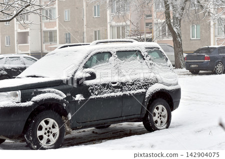 A car covered in snow. A car covered in snow. 142904075