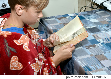 The boy is reading a book. The boy is reading a book. 142904076