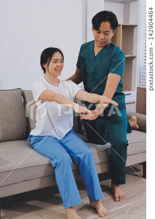 A Modern rehabilitation physiotherapy man at work with woman client A Modern rehabilitation physiotherapy man at work with woman client 142904464