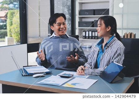 Business professional analyzing financial data on digital tablet dashboard with calculator and laptop, representing accounting software, ERP system integration, performance monitoring. 142904479