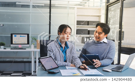 Business professional analyzing financial data on digital tablet dashboard with calculator and laptop, representing accounting software, ERP system integration, performance monitoring. Business professional analyzing financial data on digital tablet dashboard with calculator and laptop, representing accounting software, ERP system integration, performance monitoring. 142904480