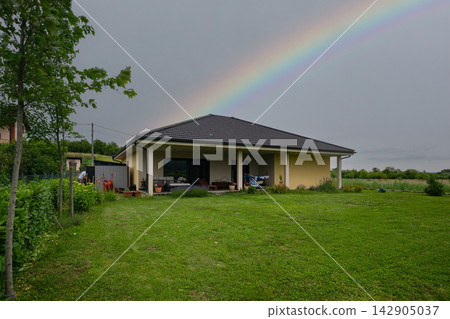 Modern modular home with minimalist design, low-energy features and a rainbow over the backyard Modern modular home with minimalist design, low-energy features and a rainbow over the backyard 142905037