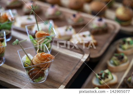 Elegant shrimp appetizers in clear cups served at a catered party or wedding reception buffet Elegant shrimp appetizers in clear cups served at a catered party or wedding reception buffet 142905077