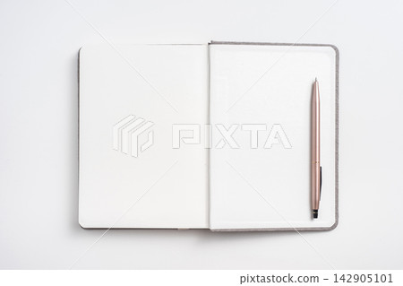 Top view of open blank notebook mockup and pen on white background Top view of open blank notebook mockup and pen on white background 142905101