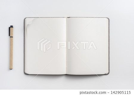 Top view of open blank notebook mockup and pen on white background 142905115