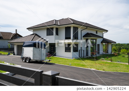 Modern modular minimalist house with trailer and energy-efficient features in suburban setting Modern modular minimalist house with trailer and energy-efficient features in suburban setting 142905224