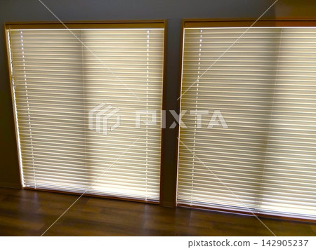 Soft light filtering in through wood-grain blinds Soft light filtering in through wood-grain blinds 142905237