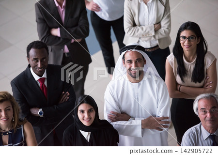 Diverse multinational business team smiling and confident in a modern corporate office setting 142905722