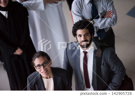 Business colleagues in formal attire looking up confidently during a corporate meeting and networking event Business colleagues in formal attire looking up confidently during a corporate meeting and networking event 142905726