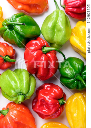 Bright habanero peppers close up on white background Bright habanero peppers close up on white background 142905805