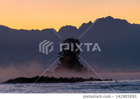 富山縣雨晴海岸的海景和暮色，沐浴在黎明的色彩中。 142905893