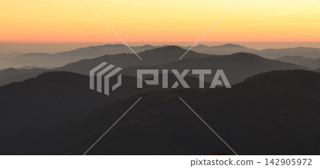 Silhouetted mountain ridges fading into the distance Silhouetted mountain ridges fading into the distance 142905972