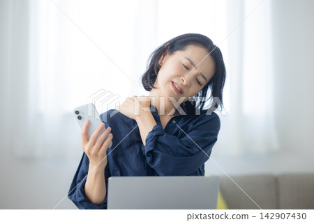 A woman using a computer A woman using a computer 142907430