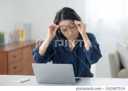 A woman using a computer A woman using a computer 142907514