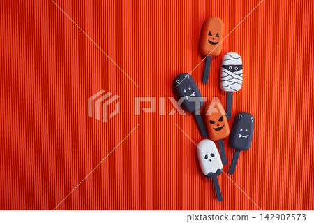 Halloween treats including pumpkin, mummy, ghost, and bat popsicles Halloween treats including pumpkin, mummy, ghost, and bat popsicles 142907573