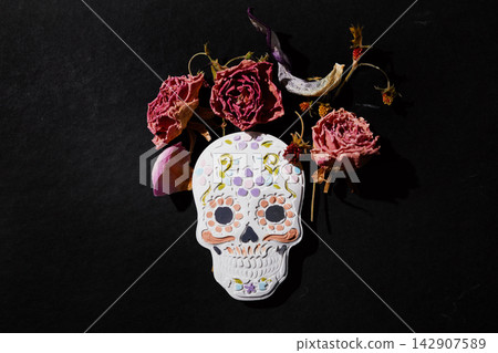 Sugar skull decorated with dried roses for dia de muertos Sugar skull decorated with dried roses for dia de muertos 142907589