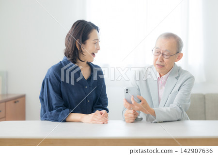 Senior man looking at smartphone Senior man looking at smartphone 142907636
