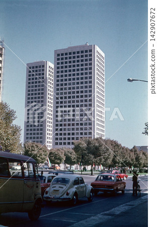 view of Saman Towers, featuring classic mid-century cars and modernist skyscraper architecture view of Saman Towers, featuring classic mid-century cars and modernist skyscraper architecture 142907672